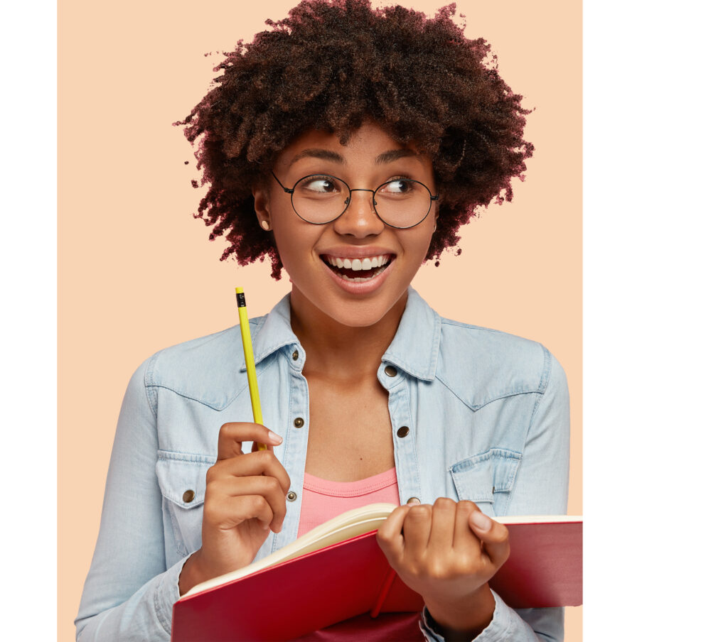 Joyful black author works on writing new book for readers, has positive expression, inspiration to work and create, carries notepad and pencil, isolated over pink background with free space for text